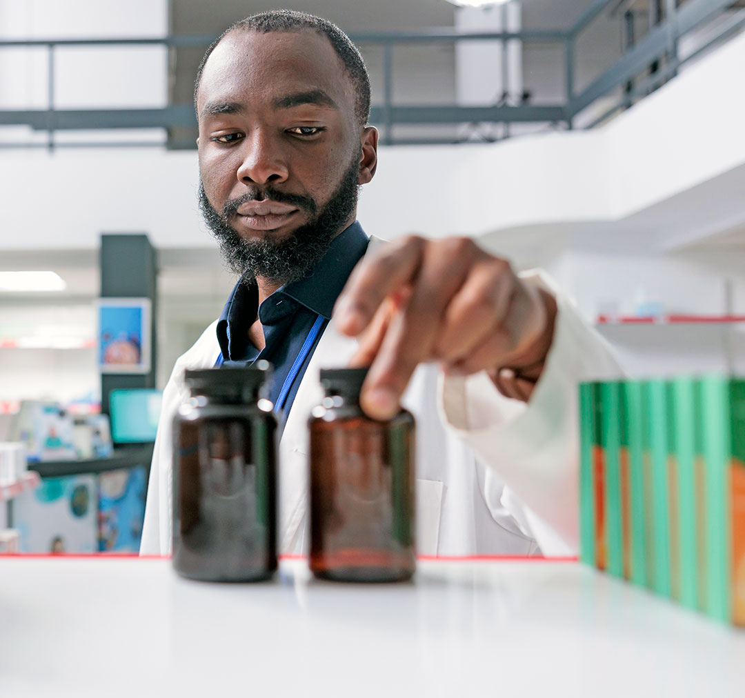 african-american-pharmacist-putting-pills-bottles